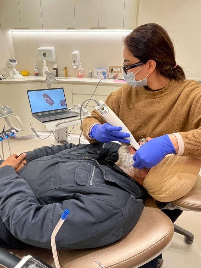Dr. Harnoor performing a digital intraoral scan for precise dental treatment planning at Gelos Dentistry in Zirakpur.